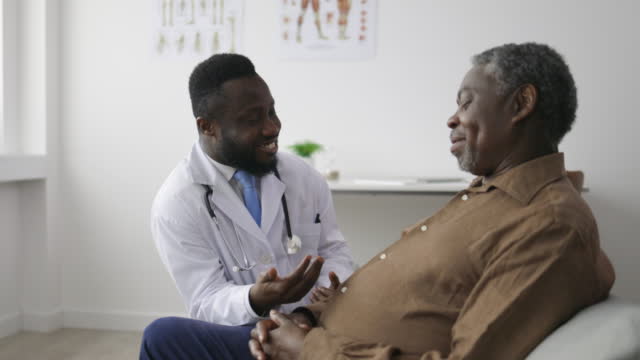 Doctor in his office talking to a senior man